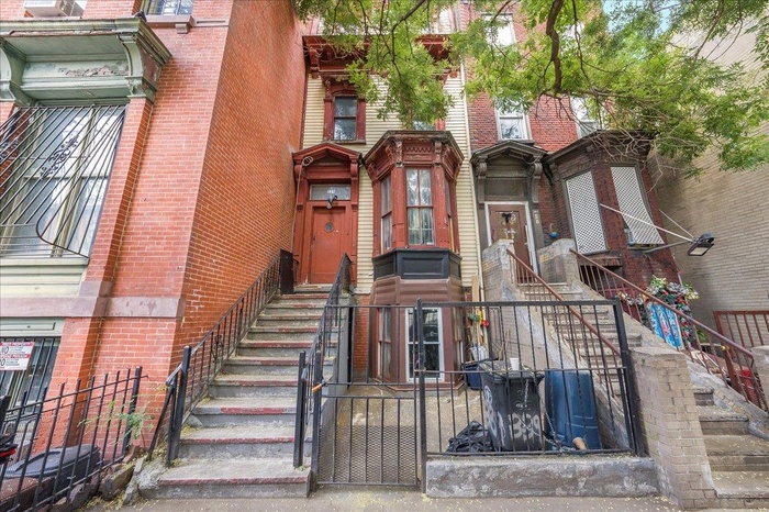 View of property featuring stairs