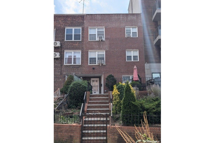 View of front of home featuring brick siding, ac unit, and cooling unit
