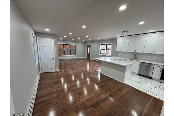 Kitchen featuring baseboards, recessed lighting, a baseboard heating unit, a sink, and dishwasher