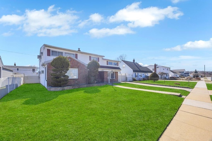 Traditional-style house featuring brick siding and a residential view