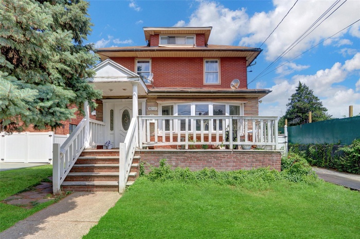 Traditional style home with brick siding and a porch