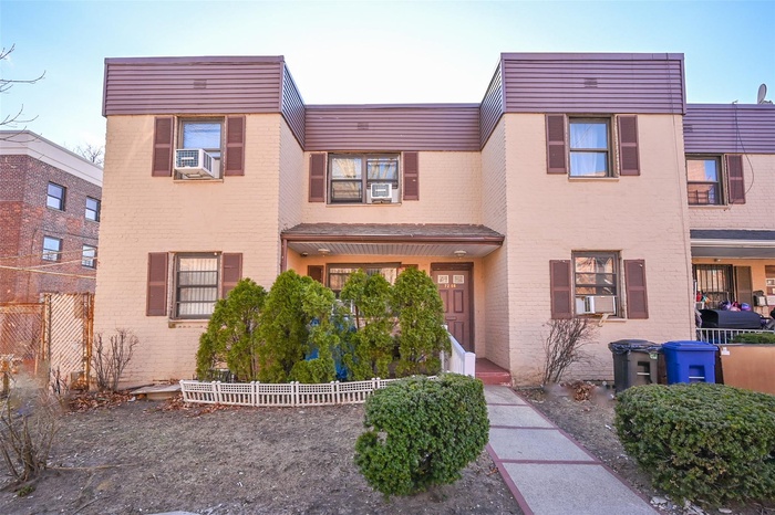 Multi unit property with brick siding, cooling unit, and fence