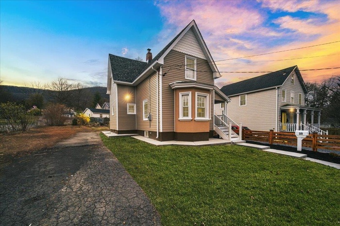 Side of house with a shingled roof, a lawn, a chimney, new asphalt driveway coming this week, and fence