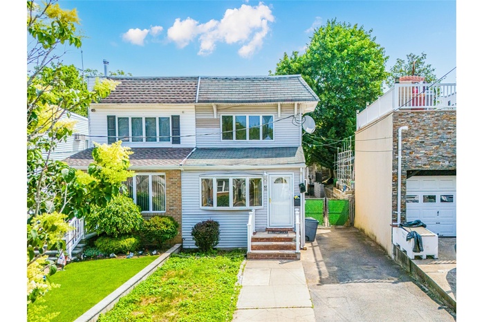 View of front of house with asphalt driveway