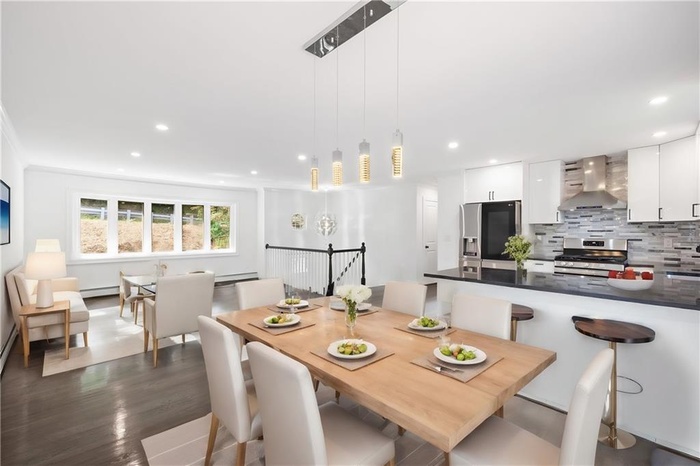 Dining area with baseboard heating, recessed lighting, and dark wood-type flooring