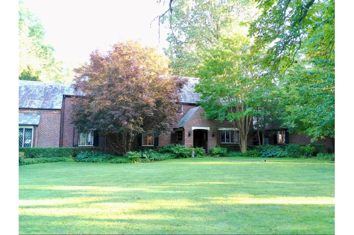 View of front of house featuring brick siding and a front lawn