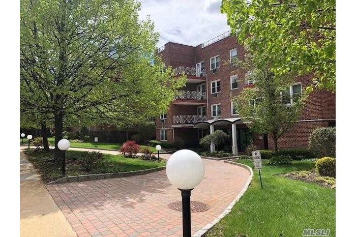 View of property's community with a yard