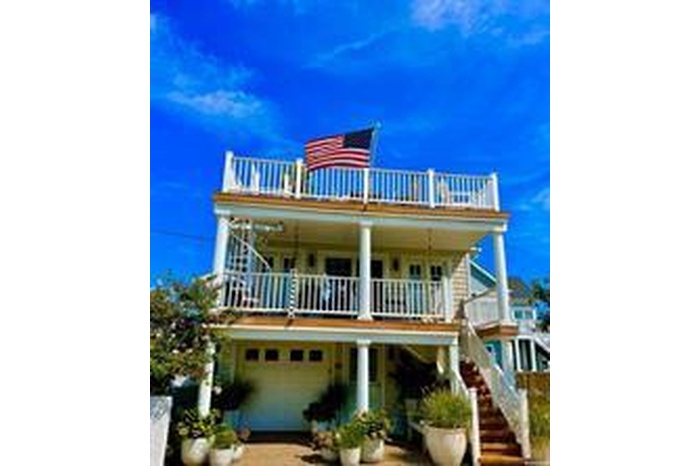 View of front facade with a balcony and an attached garage