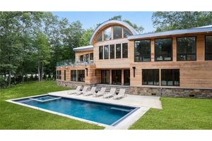 Welcome to 16 Col Sheldon, a newly completed and designer finished modern masterpiece set on four private acres in the heart of Pound Ridge.