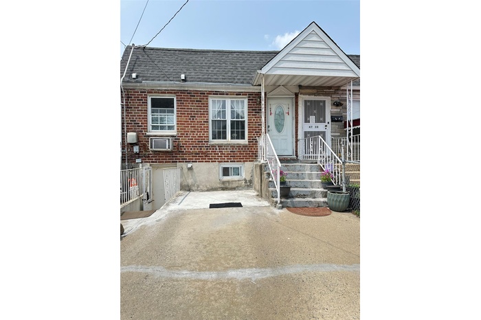 Townhome / multi-family property featuring roof with shingles and brick siding