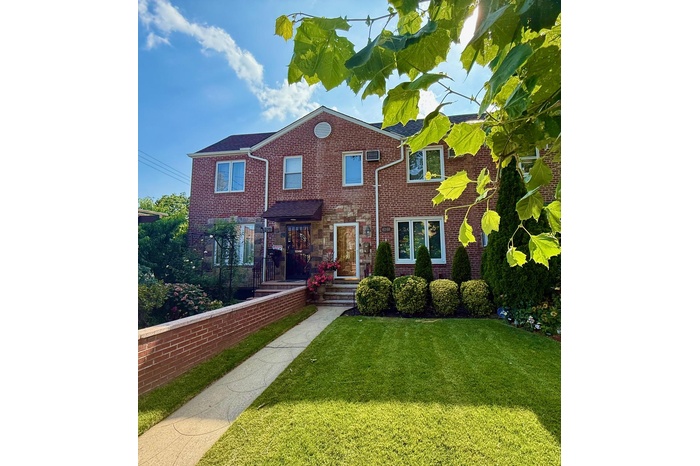 Traditional home featuring a front lawn and brick siding
