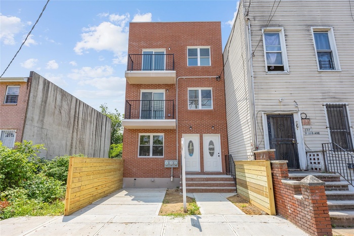 View of front facade featuring brick siding and entry steps