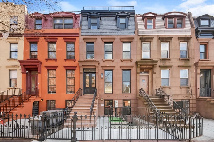 Townhome / multi-family property with a fenced front yard