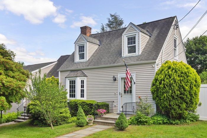 Welcome to 11 Brundage St., a Cape Cod style home featuring a chimney, a front lawn, & roof with shingles.