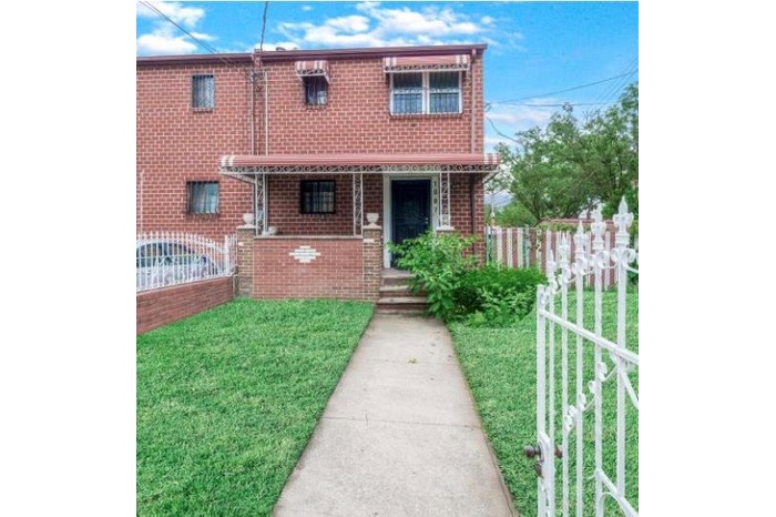 View of front of home with brick siding and a porch