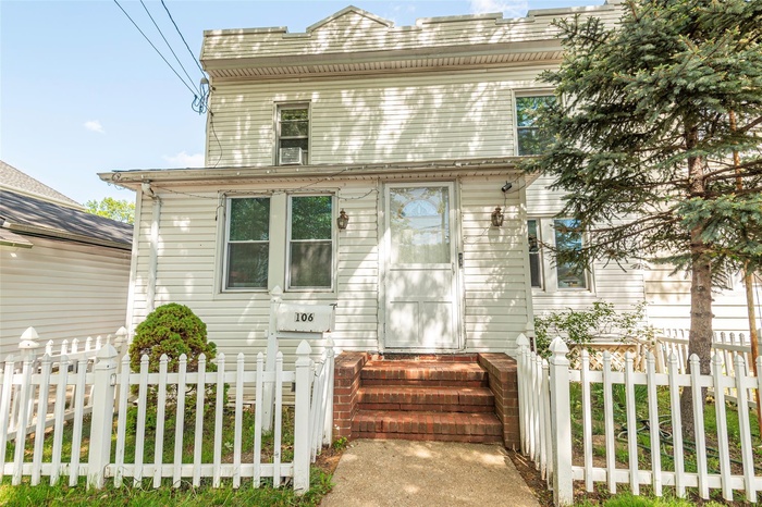 View of front of home featuring fence and entry steps