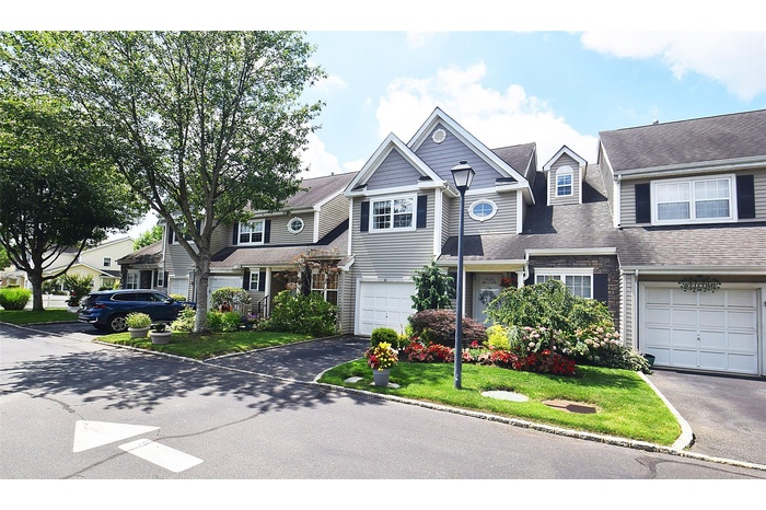 Traditional-style home featuring driveway and an attached garage