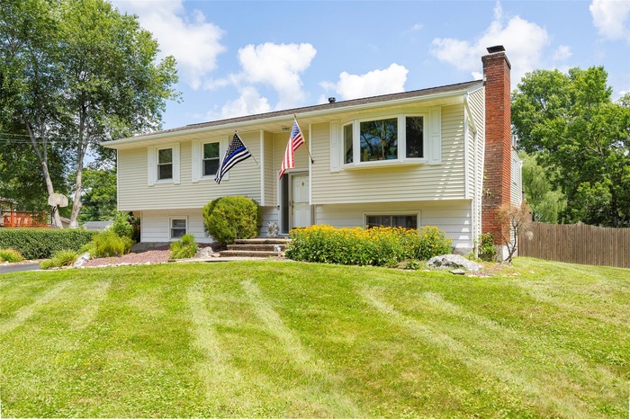 Split foyer home featuring a chimney