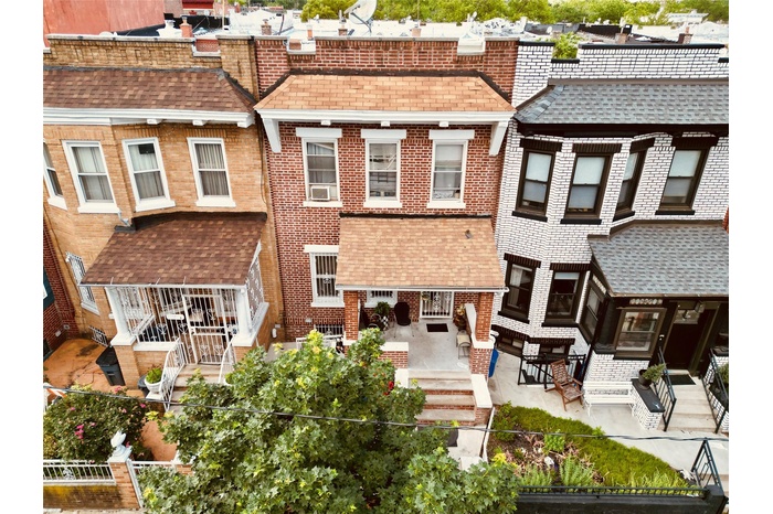 Rear view of house with brick siding and a patio