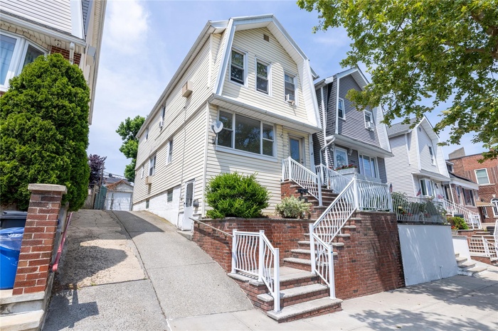 View of front of property featuring stairway and a residential view