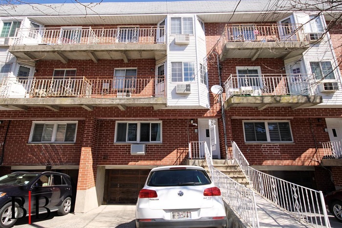 View of property featuring cooling unit and an attached garage