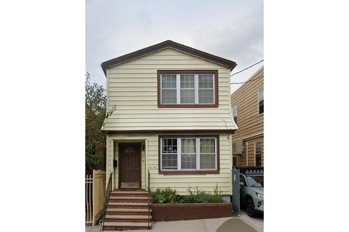 View of front of home featuring fence