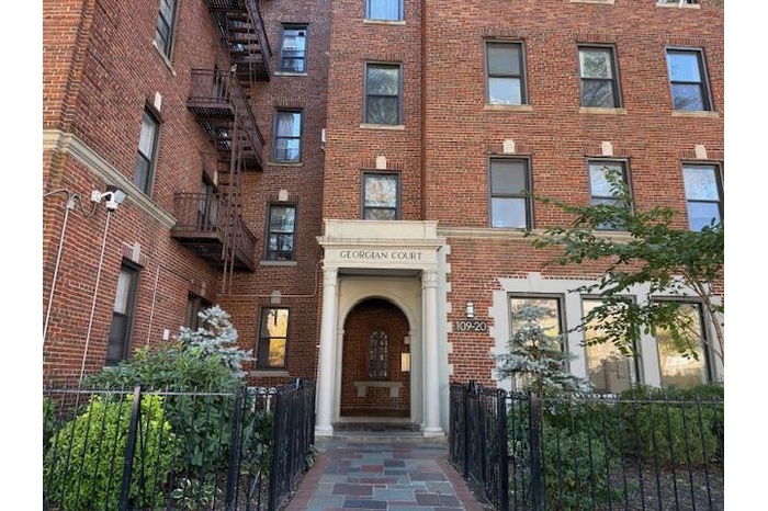 View of building exterior featuring fence