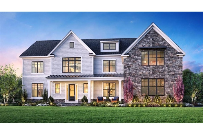 View of front of property with a standing seam roof, stone siding, a porch, and a yard