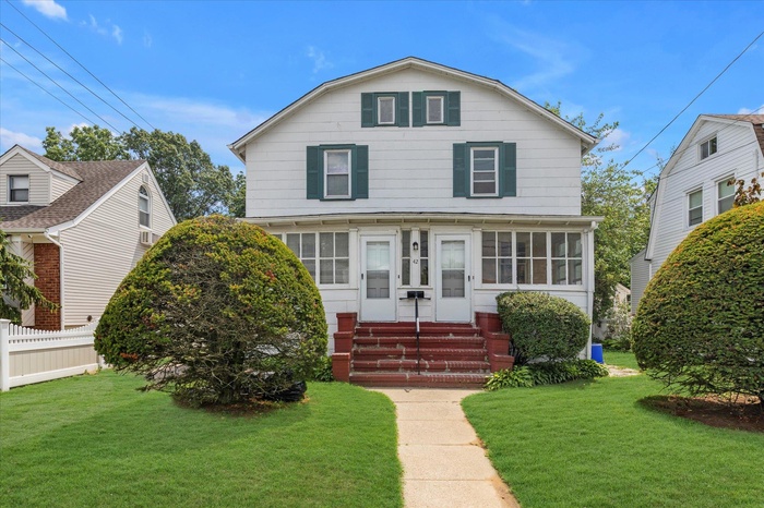 View of front of property with 2 separate entries and gambrel roof