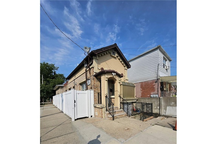 View of front of property with a gate