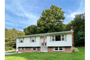 Welcome to this stunning raised ranch nestled on two combined parcels totaling just under half an acre.