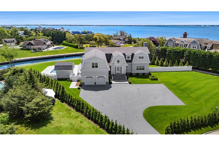 Aerial perspective of suburban area with a large body of water