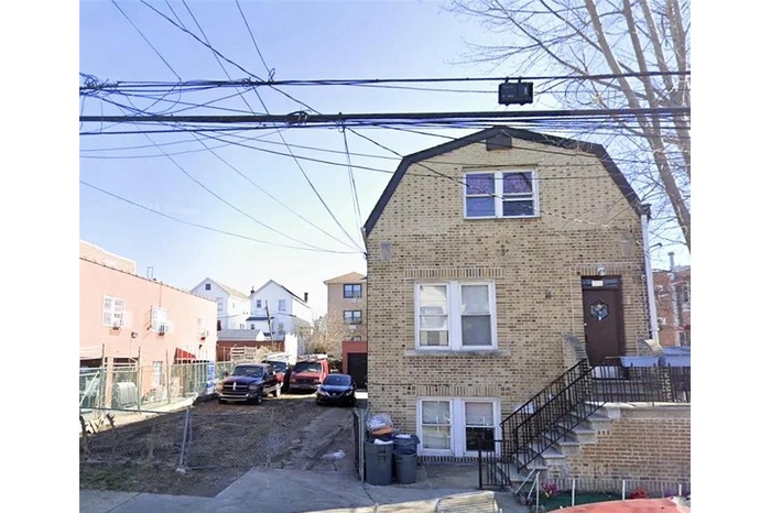 View of front of house featuring a gambrel roof, brick siding, and a residential view