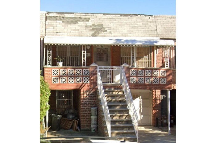 View of property featuring an attached garage and stairway