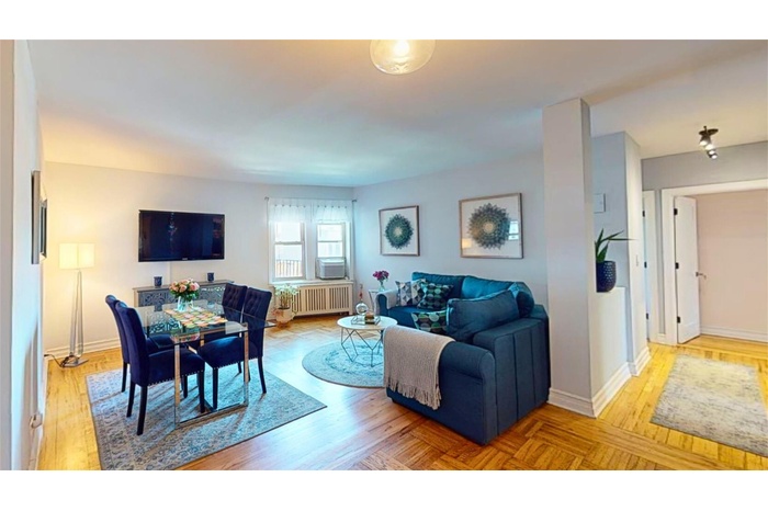 Living room featuring light parquet floors and radiator