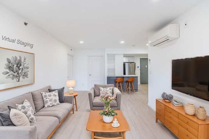 Living area featuring recessed lighting, light wood-style floors, and a wall mounted air conditioner