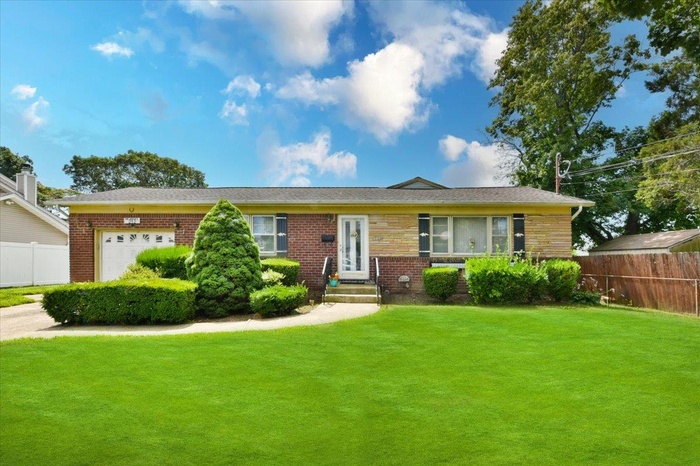 Ranch-style house featuring brick siding and an attached garage