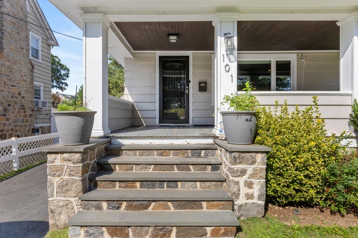 Doorway to property with covered porch