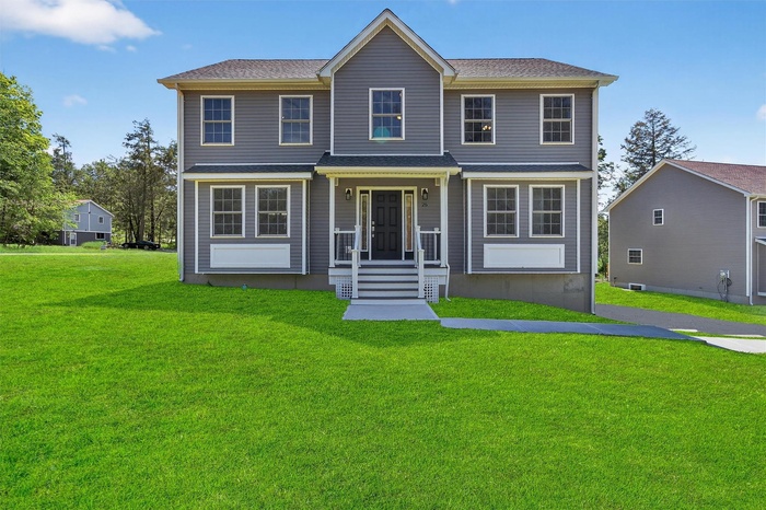 View of front of home with a front lawn and a shingled roof *Photo has been virtually altered