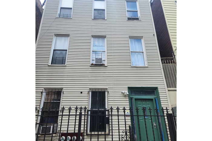 View of building exterior with a fenced front yard