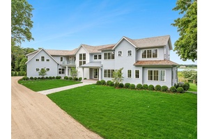 Discover the ultimate in luxury living on 3 private acres with 225 feet of bulkhead along the serene Quantuck Creek in Quiogue.