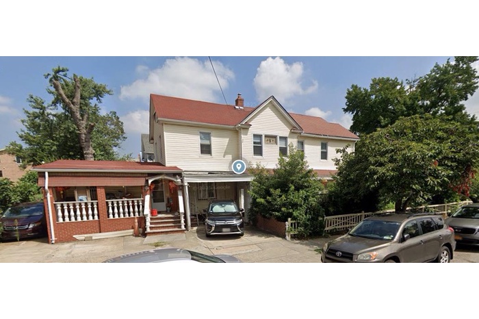 View of front of property featuring covered porch and a chimney