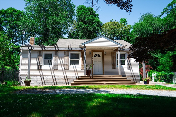 View of front of home featuring a front lawn and a chimney