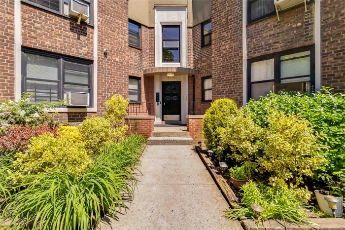 Entrance to property featuring brick siding