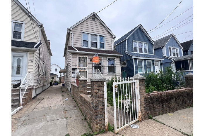 View of front facade with a gate and a residential view