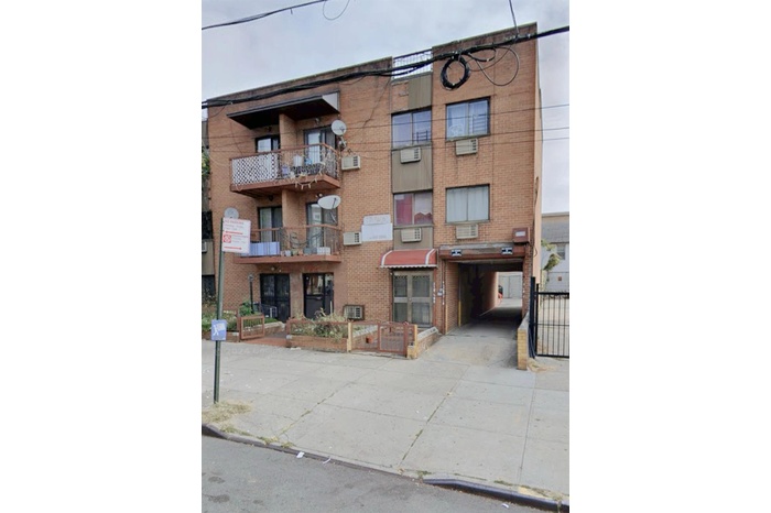 View of apartment building / complex featuring concrete driveway
