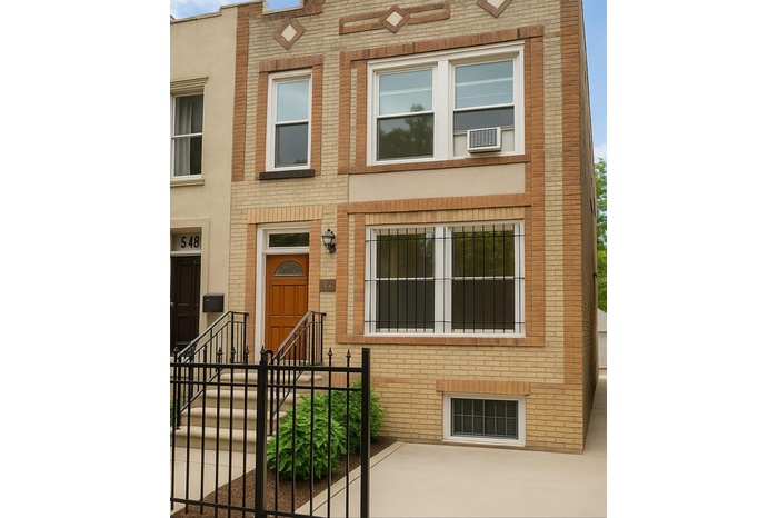 Property entrance featuring brick siding