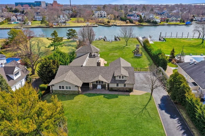 Birds eye view of property featuring a water view and a residential view