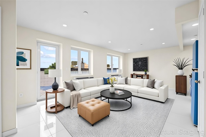 Living area with light tile patterned floors, baseboards, and recessed lighting
