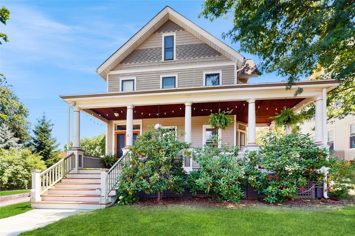 View of front of home featuring a wraparound porch